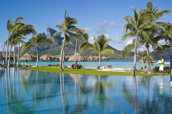 Palm trees swaying in front of mountains on the Four Seasons Resort in Bora Bora 600