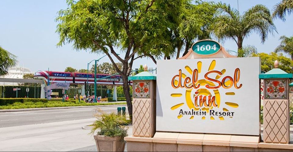 View of the Sign entering the Del Sol Inn Anaheim with Monorail passing by across the street 960