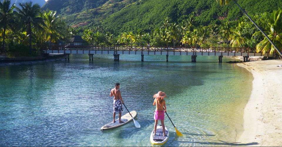 View of couple paddleboarding in the lagoon at the Intercontinenal Resort in Moorea 960