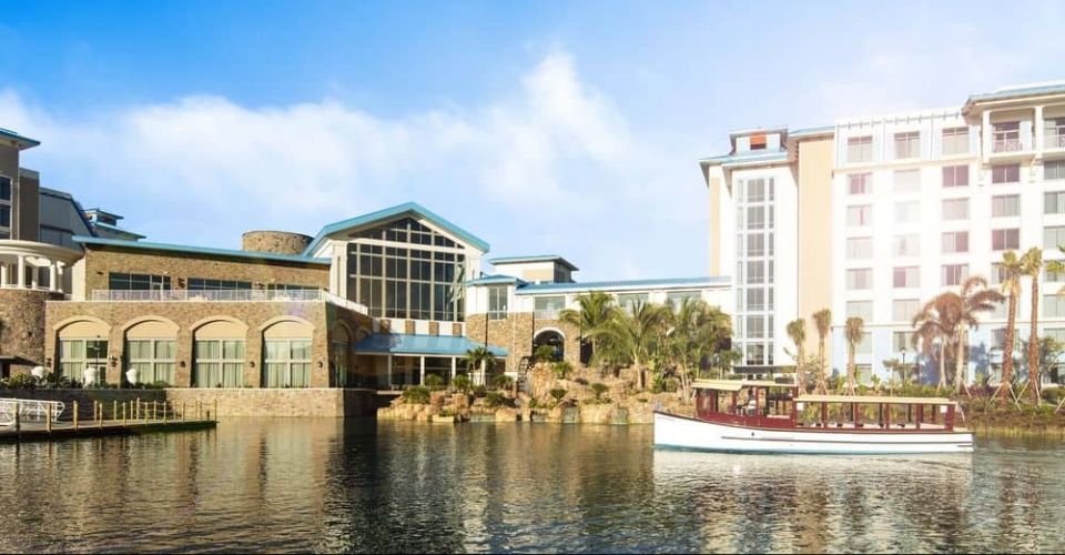 View of the Loews Sapphire Falls Resort from the back with water taxi on the water 960