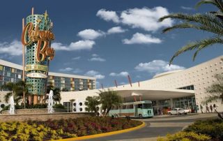 View of Cabana Bay Beach Resort Entrance with a Shuttle Bus in the front 600