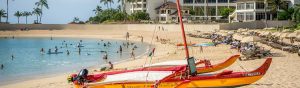 Red and Yellow Catamaran on the beach in front of a hotel in Hawaii 1200