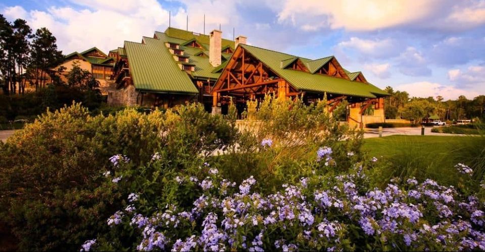 View of the entrance to the Disney Wilderness Lodge in Disney World over flowers 960