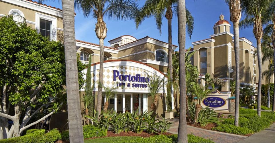 View of the Entrance to the Portofino Inn and Suites in Anaheim through the palm trees 960