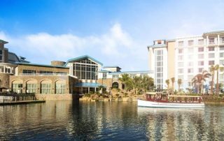 View of the Loews Sapphire Falls Resort from the back with water taxi on the water 600