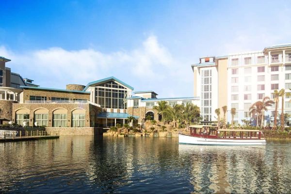View of the Loews Sapphire Falls Resort from the back with water taxi on the water 600