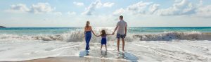 View of a young family enjoying time on the beach 1200