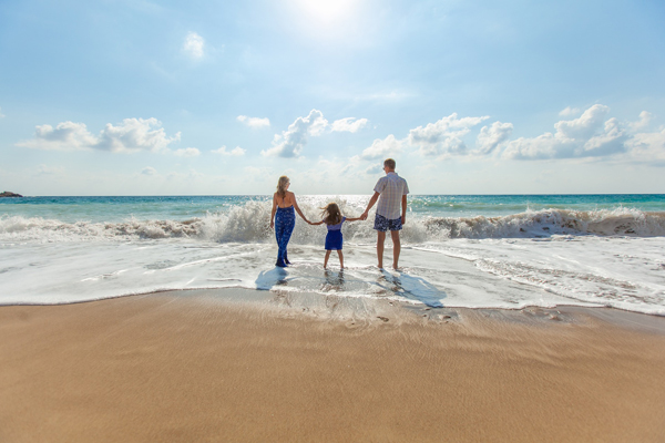 View of a young family enjoying time on the beach 600