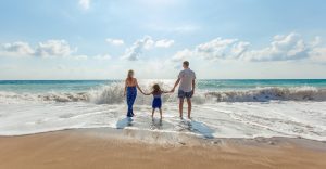 View of a young family enjoying time on the beach 960